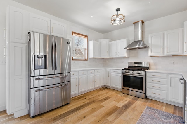 kitchen with decorative backsplash, wall chimney exhaust hood, white cabinetry, and stainless steel appliances