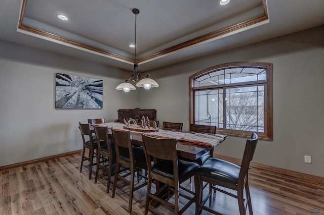 6642 Carnoustie Ct, Rapid City, SD 57702 - dining space featuring a raised ceiling, baseboards, and wood finished floors