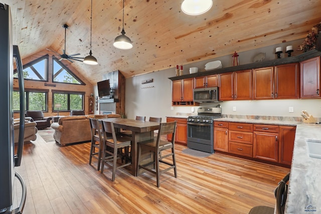 21298 Ridgewood Trl, Lead, SD 57754 - kitchen featuring light wood-style floors, light countertops, open floor plan, and appliances with stainless steel finishes