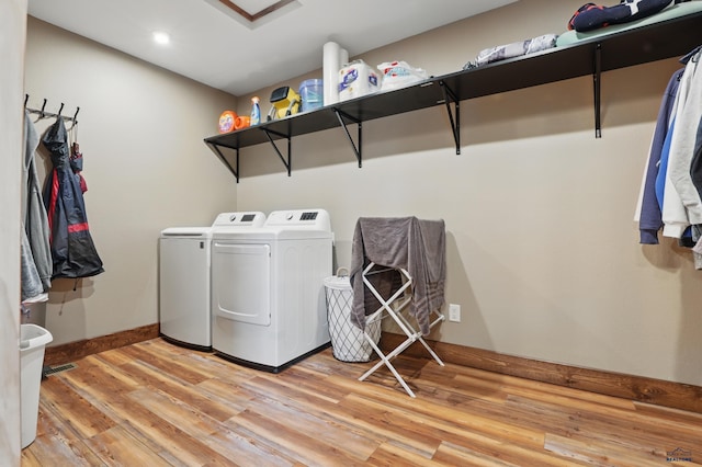 21298 Ridgewood Trl, Lead, SD 57754 - washroom with laundry area, baseboards, light wood-style flooring, and washing machine and clothes dryer