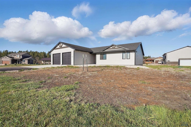 ranch-style home featuring concrete driveway and an attached garage