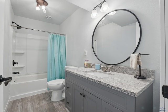 bathroom featuring vanity, shower / bath combo, toilet, and wood finished floors