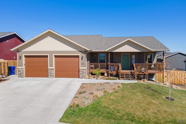 950 Summerfield Dr, Rapid City, SD 57703 - craftsman house with a porch, roof with shingles, fence, and an attached garage