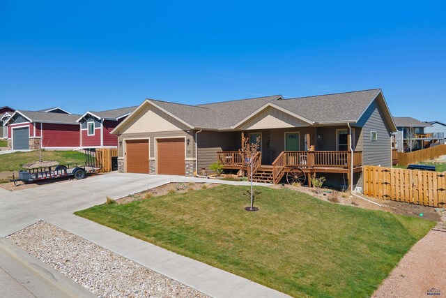 950 Summerfield Dr, Rapid City, SD 57703 - ranch-style home featuring a garage, fence, a front yard, a porch, and driveway