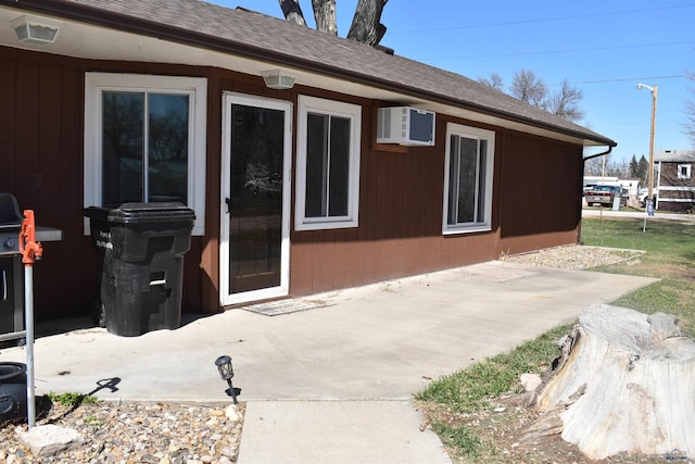 2911 Orchard Ln, Rapid City, SD 57701 - exterior space with a shingled roof, a patio, and a wall mounted AC