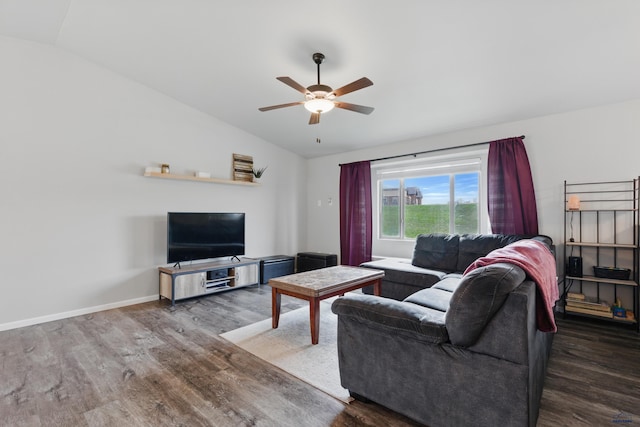 living room featuring lofted ceiling, wood finished floors, a ceiling fan, and baseboards