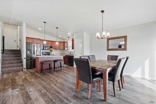 dining area featuring dark wood-style flooring, vaulted ceiling, a chandelier, stairs, and baseboards