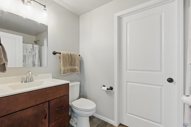 bathroom with toilet, baseboards, vanity, wood finished floors, and a shower with curtain