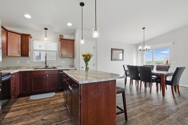 kitchen featuring a sink, dark wood-style floors, light countertops, a center island, and a chandelier