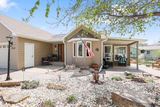 7315 Raven Ct, Rapid City, SD 57702 - rear view of property featuring a wooden deck, an attached garage, and roof with shingles