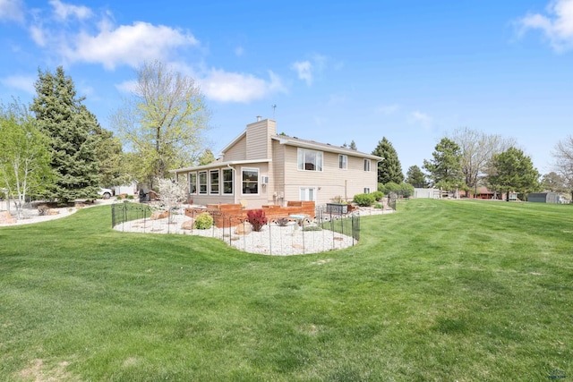 7315 Raven Ct, Rapid City, SD 57702 - rear view of property featuring a chimney, a patio area, and a lawn