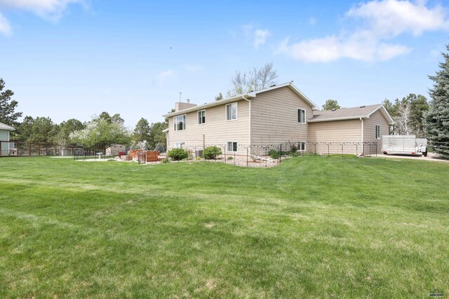 7315 Raven Ct, Rapid City, SD 57702 - back of house with a chimney