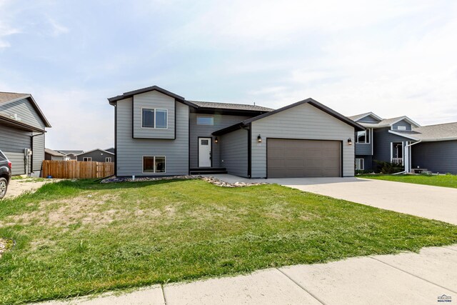 tri-level home featuring an attached garage and concrete driveway
