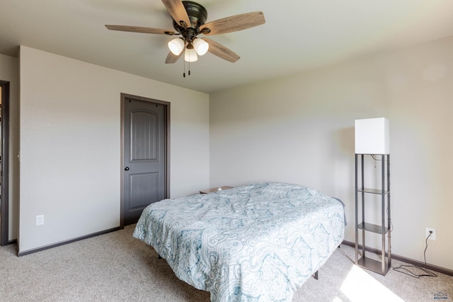 bedroom featuring light carpet and baseboards