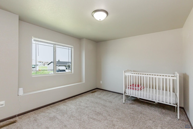 unfurnished bedroom featuring carpet flooring and baseboards