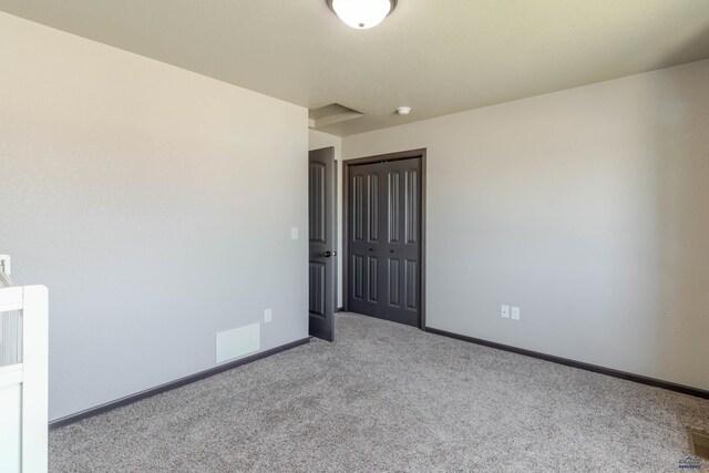 empty room with carpet floors and baseboards
