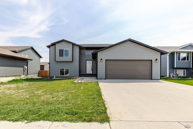 tri-level home featuring a garage and concrete driveway