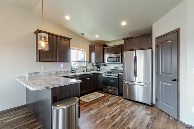 kitchen with stainless steel appliances, dark brown cabinetry, a peninsula, dark wood-style flooring, and recessed lighting