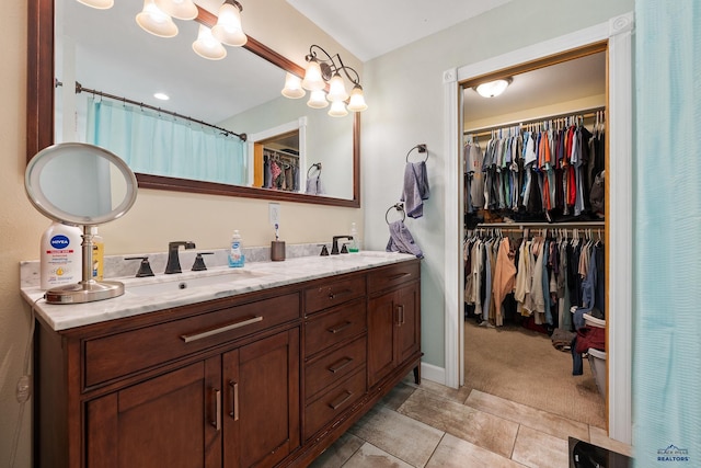 1580 Laurel Heights Dr, Rapid City, SD 57701 - bathroom featuring double vanity, a spacious closet, and a chandelier
