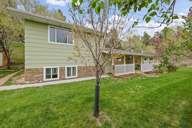 1580 Laurel Heights Dr, Rapid City, SD 57701 - back of house featuring a lawn and covered porch