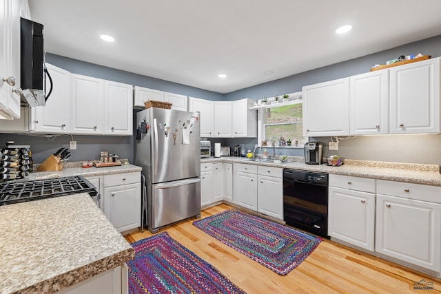 1580 Laurel Heights Dr, Rapid City, SD 57701 - kitchen with freestanding refrigerator, dishwasher, a sink, light wood-style flooring, and light countertops