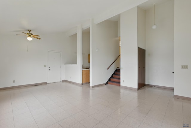 322 Curtis, Rapid City, SD 57702 - spare room with high vaulted ceiling, a ceiling fan, stairway, and baseboards