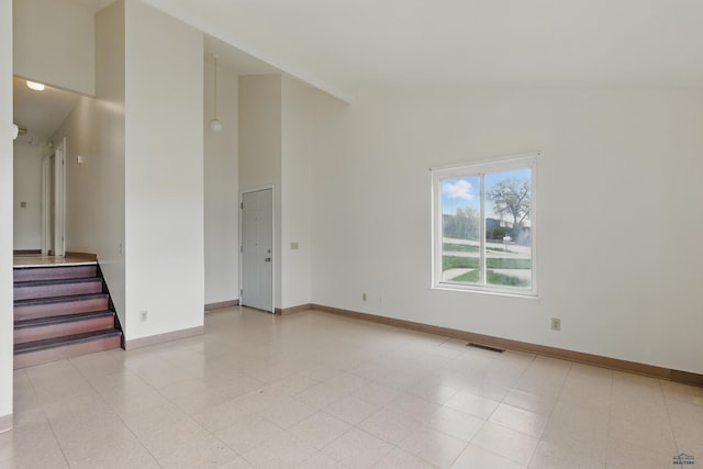 322 Curtis, Rapid City, SD 57702 - empty room with high vaulted ceiling, stairs, and baseboards