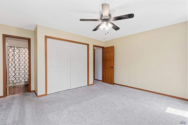 unfurnished bedroom with light carpet, a closet, baseboards, and ceiling fan