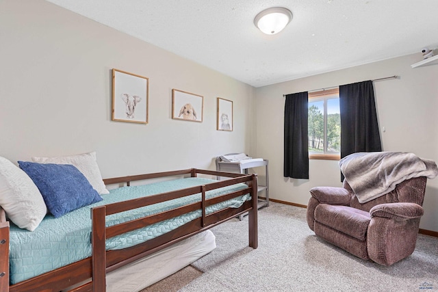 bedroom with carpet floors and baseboards