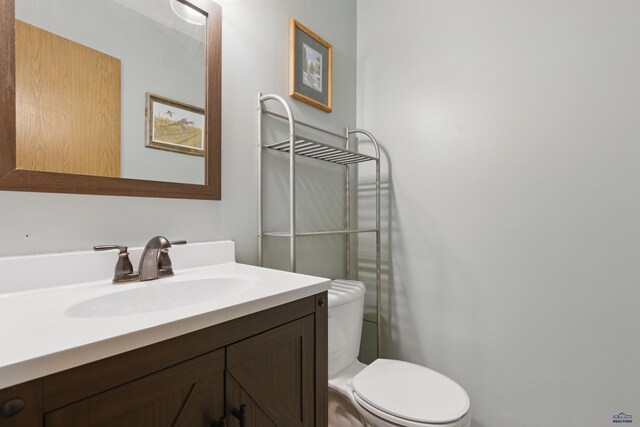 bathroom with toilet and vanity