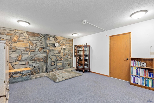 sitting room featuring a textured ceiling and carpet floors