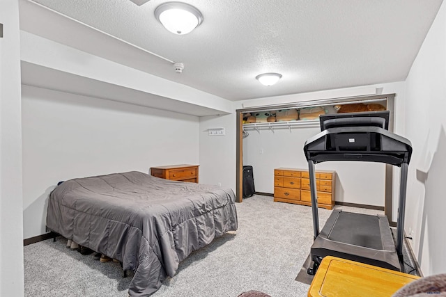 carpeted bedroom featuring a textured ceiling and a closet