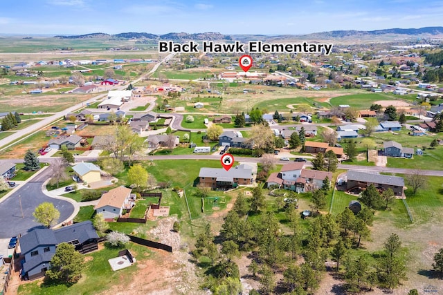 aerial view of property and surrounding area featuring a mountainous background and nearby suburban area