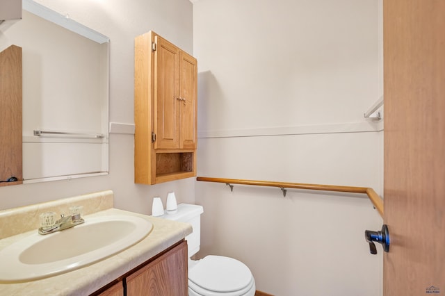 bathroom featuring toilet and vanity