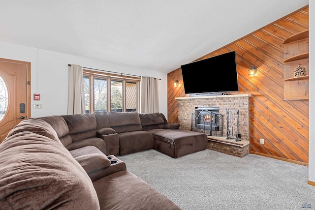 carpeted living area featuring wooden walls, a brick fireplace, and vaulted ceiling
