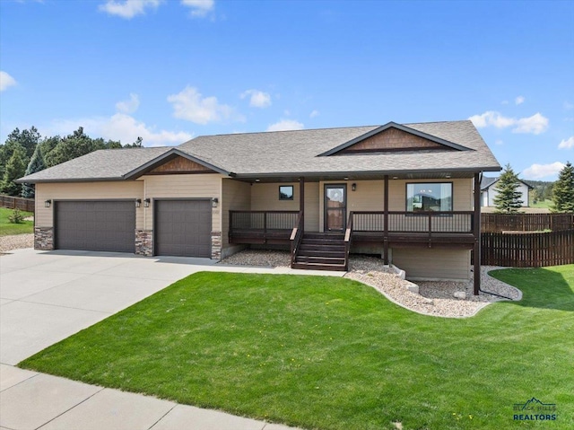 view of front of home featuring an attached garage, concrete driveway, roof with shingles, and a porch