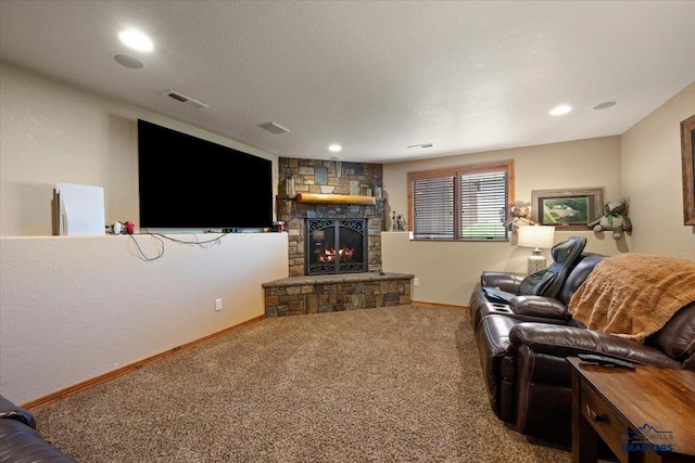 carpeted living room with a stone fireplace, baseboards, and recessed lighting
