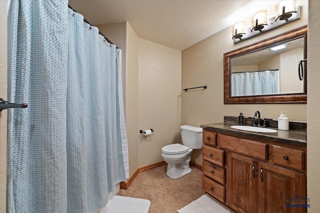 bathroom with toilet, tile patterned floors, vanity, a textured ceiling, and baseboards