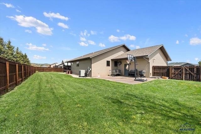 rear view of house with central AC and a patio area