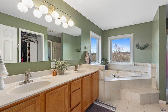 4037 Valley W Dr, Rapid City, SD 57702 - bathroom featuring tile patterned flooring, a garden tub, double vanity, a spacious closet, and a shower with shower door
