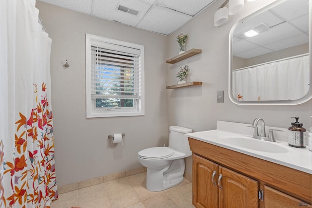 4037 Valley W Dr, Rapid City, SD 57702 - full bathroom with a drop ceiling, toilet, vanity, baseboards, and tile patterned floors