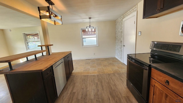 2408 Judy Ave, Rapid City, SD 57702 - kitchen featuring stainless steel appliances, butcher block countertops, healthy amount of natural light, and light wood finished floors