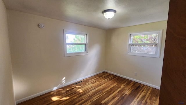 2408 Judy Ave, Rapid City, SD 57702 - spare room with healthy amount of natural light, wood-type flooring, and baseboards