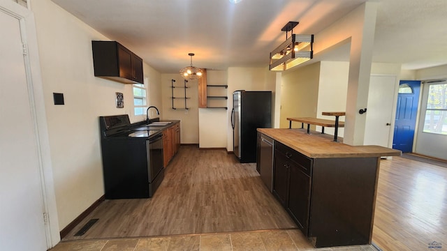 2408 Judy Ave, Rapid City, SD 57702 - kitchen featuring appliances with stainless steel finishes, a sink, butcher block counters, light wood-style flooring, and baseboards