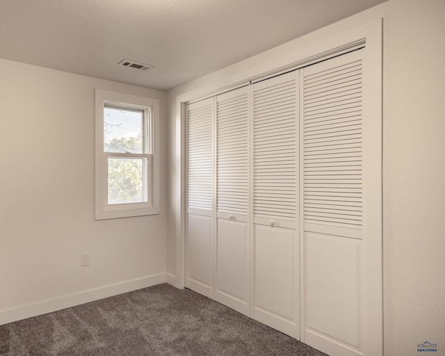 3432 Jackson Blvd, Rapid City, SD 57702 - unfurnished bedroom with dark colored carpet, a closet, and baseboards