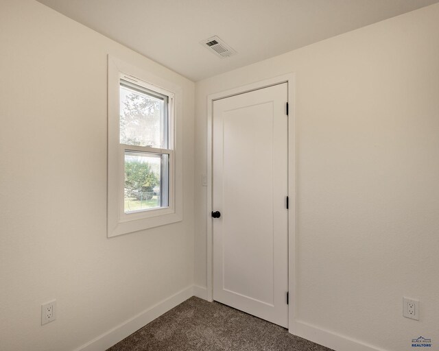 3432 Jackson Blvd, Rapid City, SD 57702 - unfurnished bedroom with dark carpet and baseboards