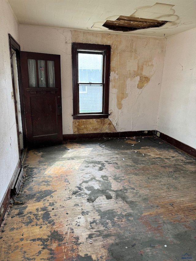 unfurnished room featuring baseboards