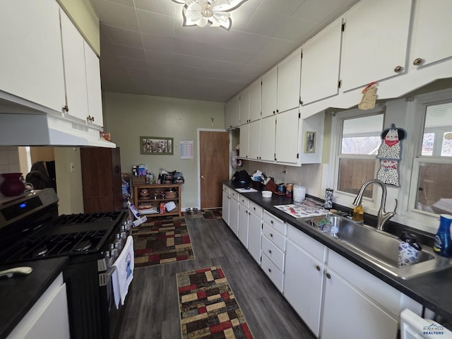 142 W Summit, Lead, SD 57754 - kitchen featuring stainless steel gas range, a sink, white cabinetry, and dark countertops
