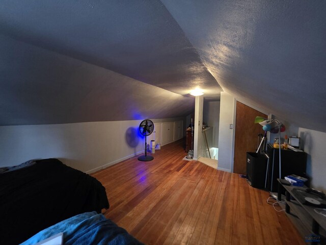 142 W Summit, Lead, SD 57754 - bedroom with wood finished floors, vaulted ceiling, and baseboards