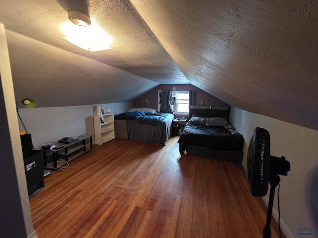 142 W Summit, Lead, SD 57754 - bedroom featuring wood finished floors, a textured ceiling, and lofted ceiling